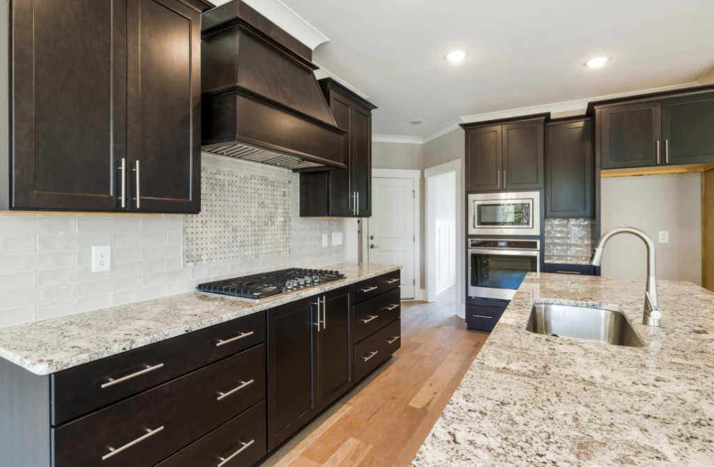 Modern kitchen with dark cabinetry and granite countertops