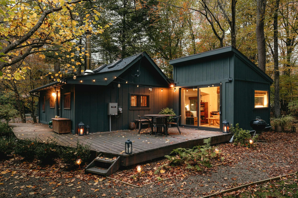 A beautiful blue roof cabin can be seen in a forest with the autumn season