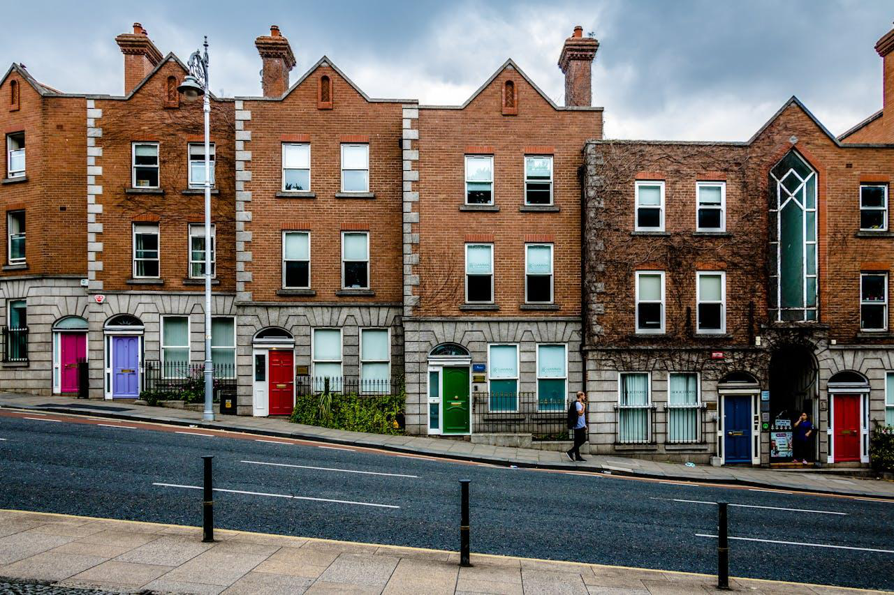 Brown houses can be seen joined together on a downward slope