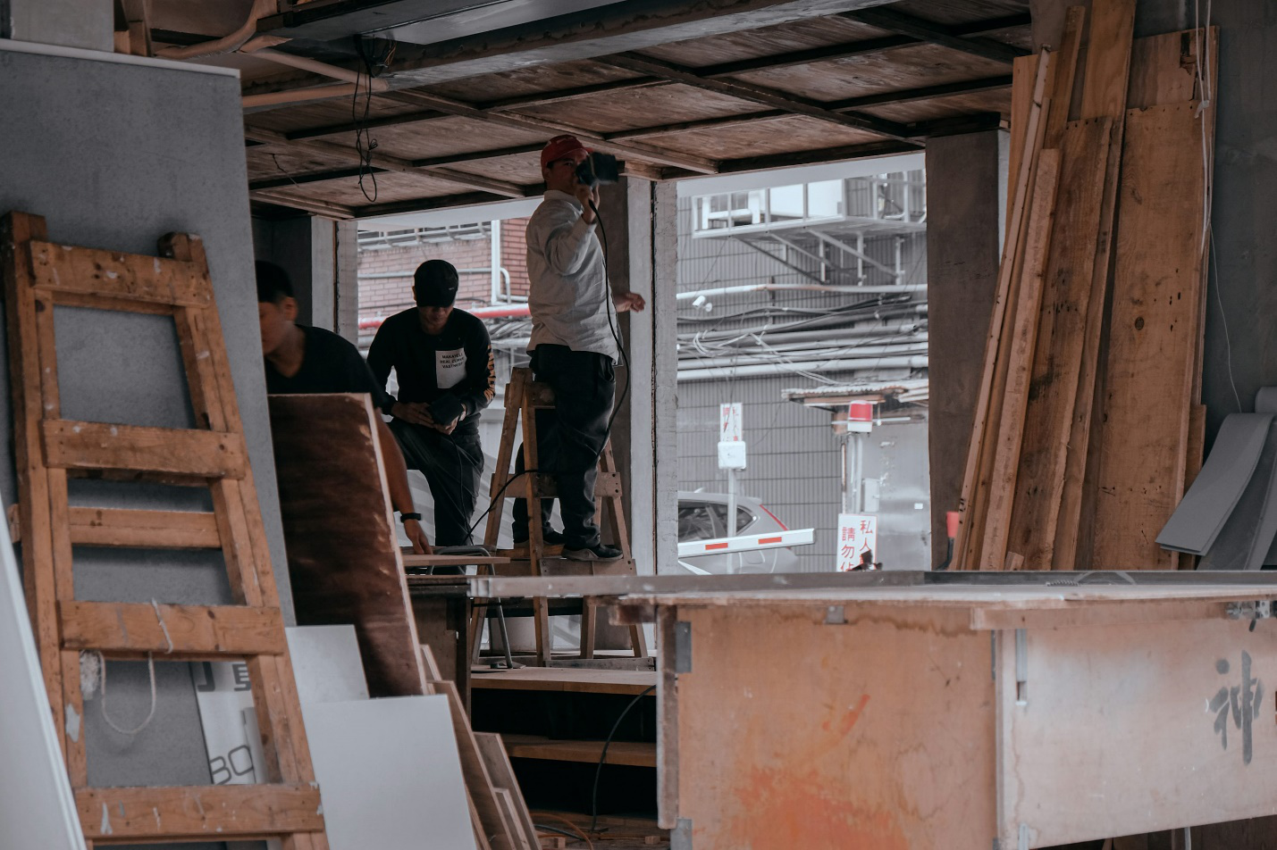  An image of three builders working on a construction site.
