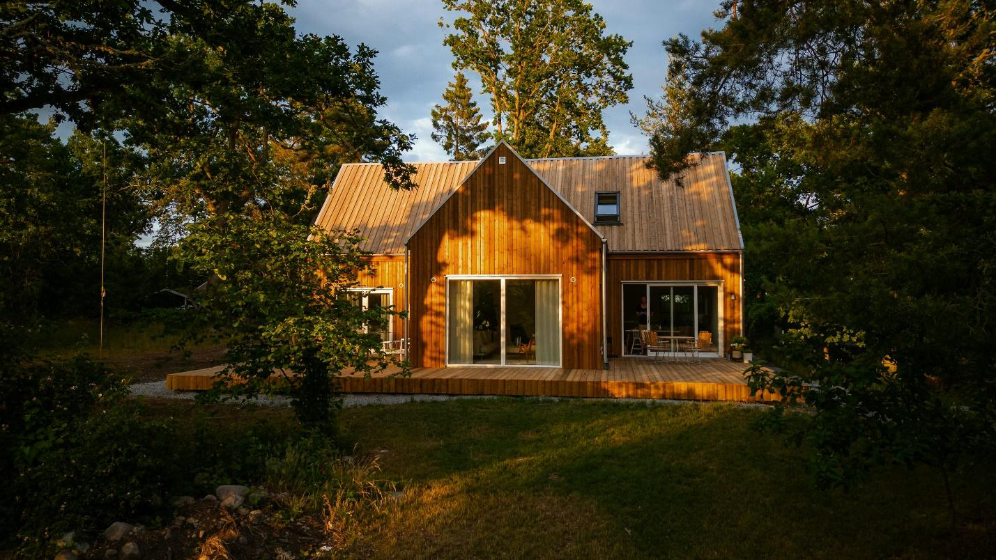 A wooden cabin surrounded by woods.