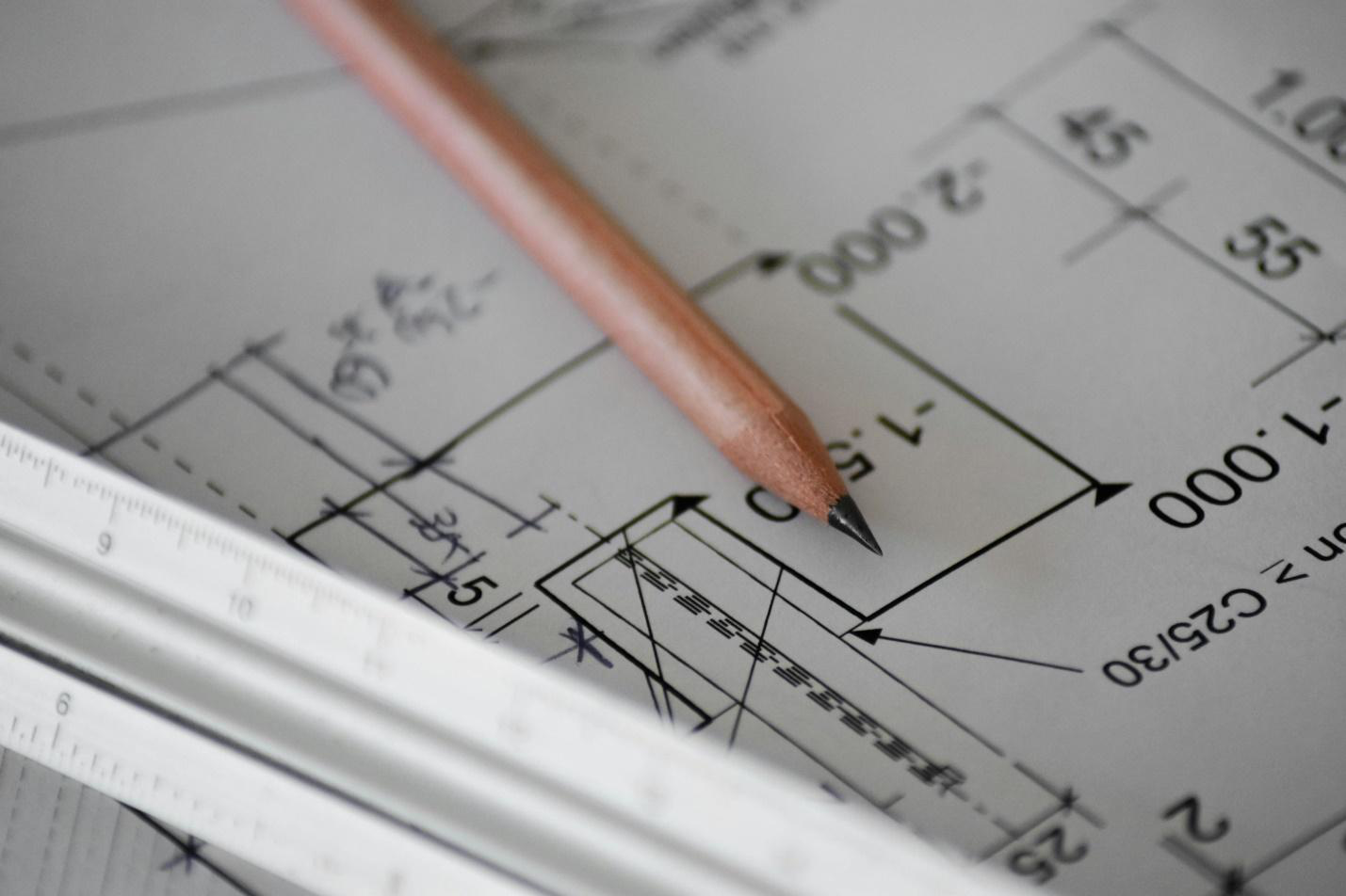 A close-up image of a floor plan and pencil.